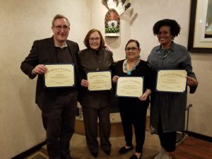 Regina Rodriguez Sisneros, receiving her certificate of completion